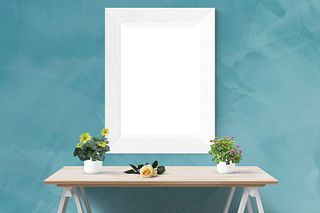 two potted petaled flowers on white vases on top of brown wooden table thumbnail