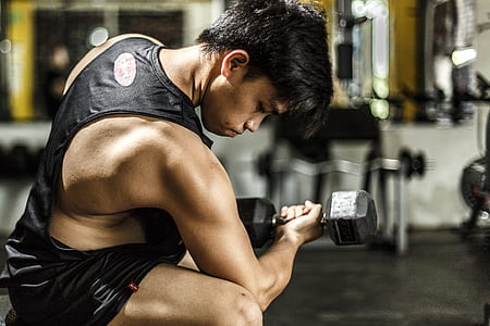 Woman Wearing Black Tank Top Taking Work Out thumbnail