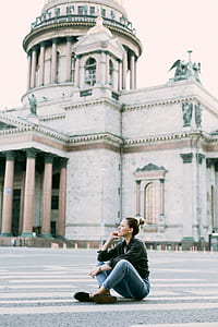 Woman Wearing Black Long-sleeved Shirt and Blue-washed Boyfriends Jeans Sitting Gesture thumbnail