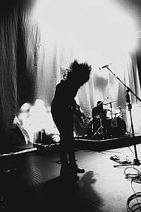 grayscale photography of person playing guitar thumbnail