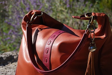 brown leather shoulder bag on gray soil thumbnail
