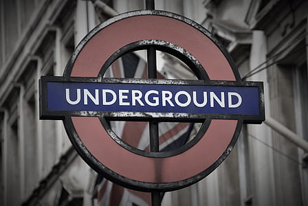 shallow focus photo of red and blue Underground signage thumbnail