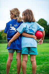 two girls standing on an open field thumbnail