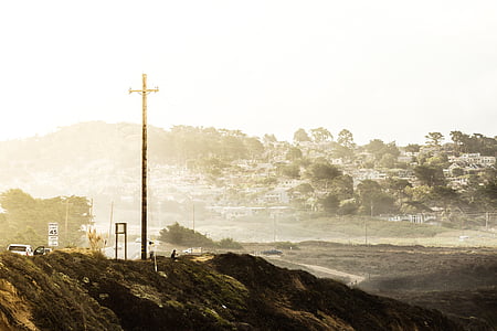 cross near road at daytime thumbnail