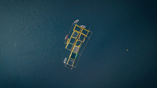 top view photo of boats beside fish pen thumbnail