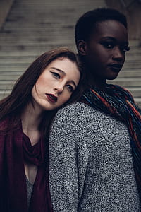 two women stands near white surface at daytime thumbnail