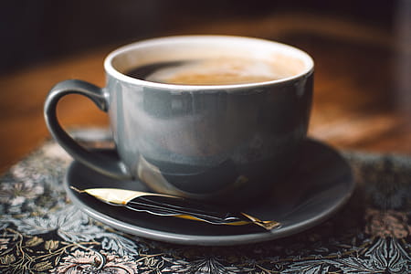 Gray Ceramic Cup of Coffee on Round Gray Saucer thumbnail