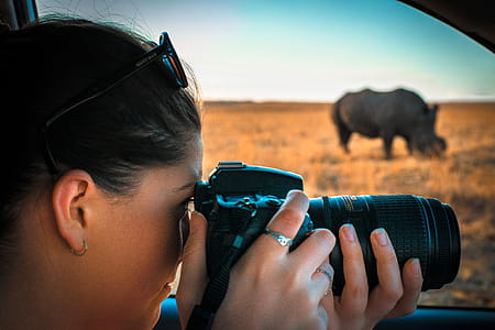 Woman Holding Black Dslr Camera thumbnail