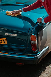 person cleaning car during daytime thumbnail