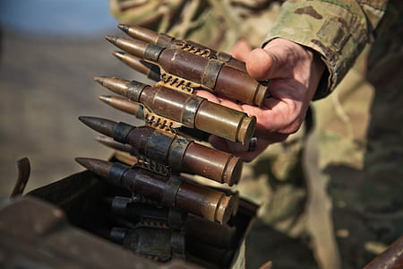 person holding ammunition belt thumbnail