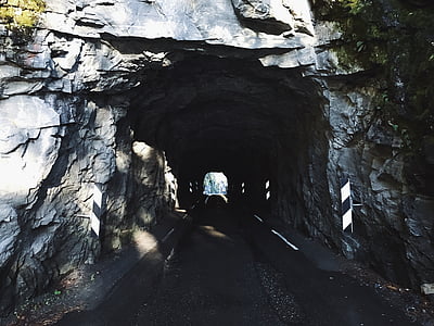 gray rock tunnel during daytime thumbnail