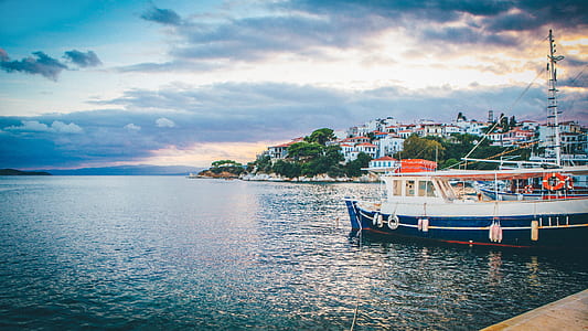 white and blue boat on body of water during daytime thumbnail