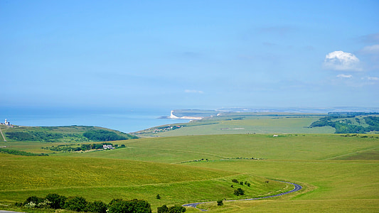 green grass field under blue sky at daytime thumbnail