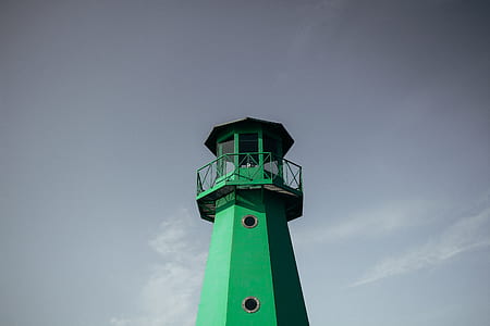 low angle photography of green lighthouse thumbnail