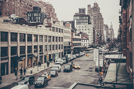 photography of cars in road beside white building thumbnail