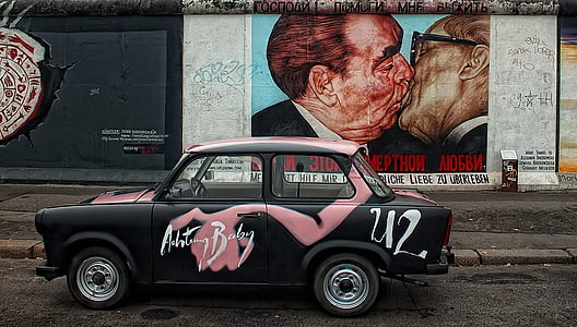 black and pink sedan beside two man kissing wall paint thumbnail