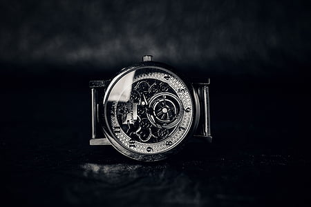 round silver-colored skeleton watch on black surface thumbnail