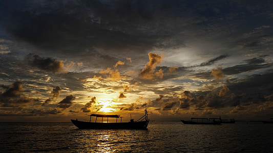 silhouette of boat in golden hour background thumbnail