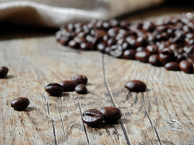 coffee beans lot on brown wooden table thumbnail