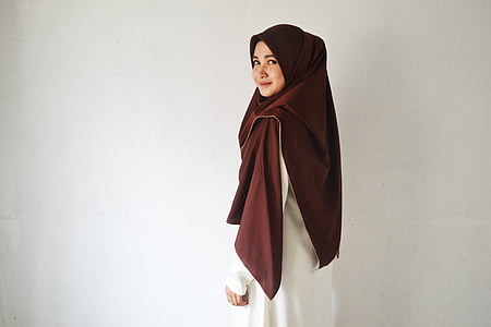 woman standing against white wall thumbnail