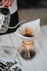 Woman pouring water in Chemex filter coffee maker thumbnail