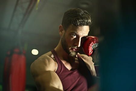A young bearded caucasian man wearing boxing gloves thumbnail