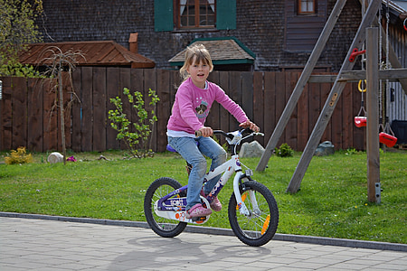 girl riding on white bicycle thumbnail