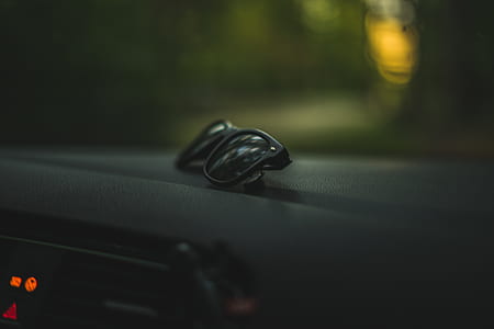 black wayfarer sunglasses in car dashboard thumbnail