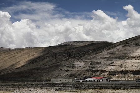 buildings near mountain during daytime thumbnail