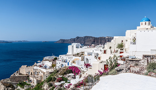 panoramic photography of white concrete building beside wide ocean during daytime thumbnail