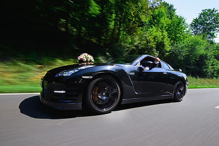 black coupe surrounded trees thumbnail