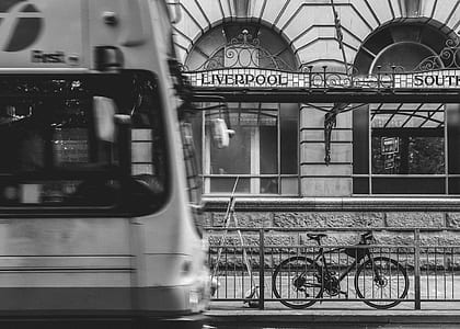 grayscale photography of parked bicycle near the train station thumbnail