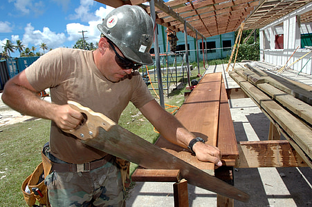 man holding wood saw thumbnail