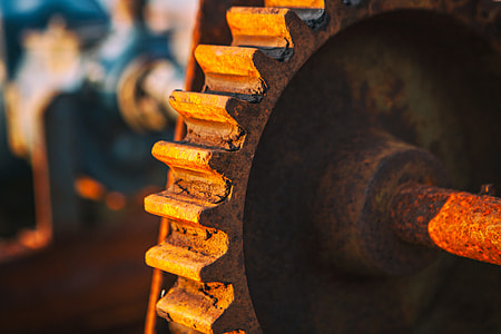 Close-up sunlit shot of an old rusty cog. Image captured in Dungeness, Kent, England thumbnail
