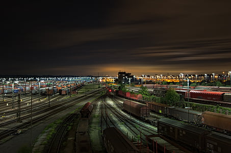 red and black train rail at night time thumbnail
