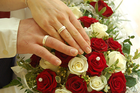 couple wearing silver-colored wedding rings thumbnail
