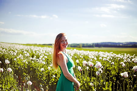 woman standing in poppy flower field thumbnail