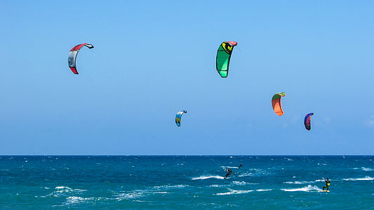 people parachuting over body of water during daytime thumbnail