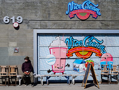 person sitting on bench beside Nice Cream graffiti thumbnail