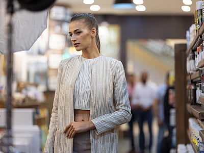 woman standing near wooden shelf in shallow-focus shot thumbnail