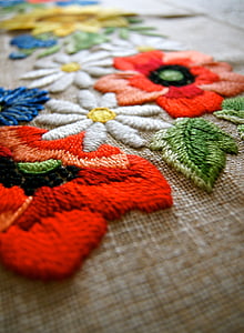 shallow focus photography of assorted-color floral embroidered textile thumbnail