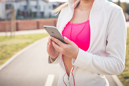 woman holding silver iPhone 6 in middle of road thumbnail