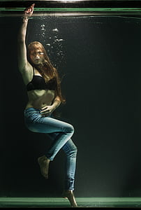 woman in black brassiere inside water tank thumbnail