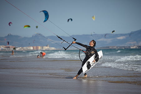 man playing water sports during daytime thumbnail