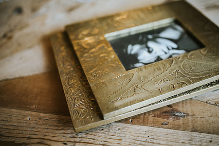 Golden photo frame and decorative paper on a table thumbnail