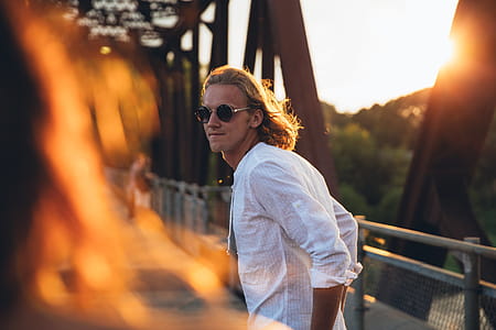 Man Looks At Woman In Sunset Photo thumbnail