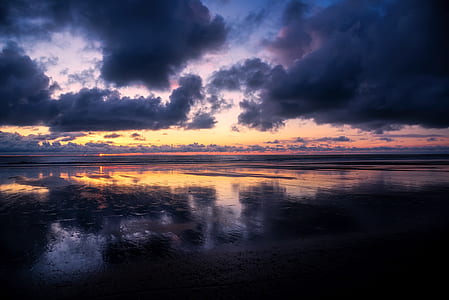 silhouette photo of calm water with clouds photo thumbnail