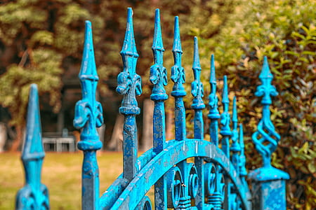 shallow focus of blue wrought iron gate thumbnail