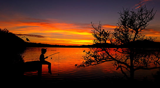 silhouette of boy fishing on dock thumbnail
