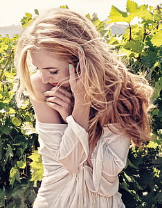 woman in white shirt beside plants during daytime thumbnail